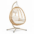 Hängesessel aus Rattan mit Stahlgestell und beige Kissen
